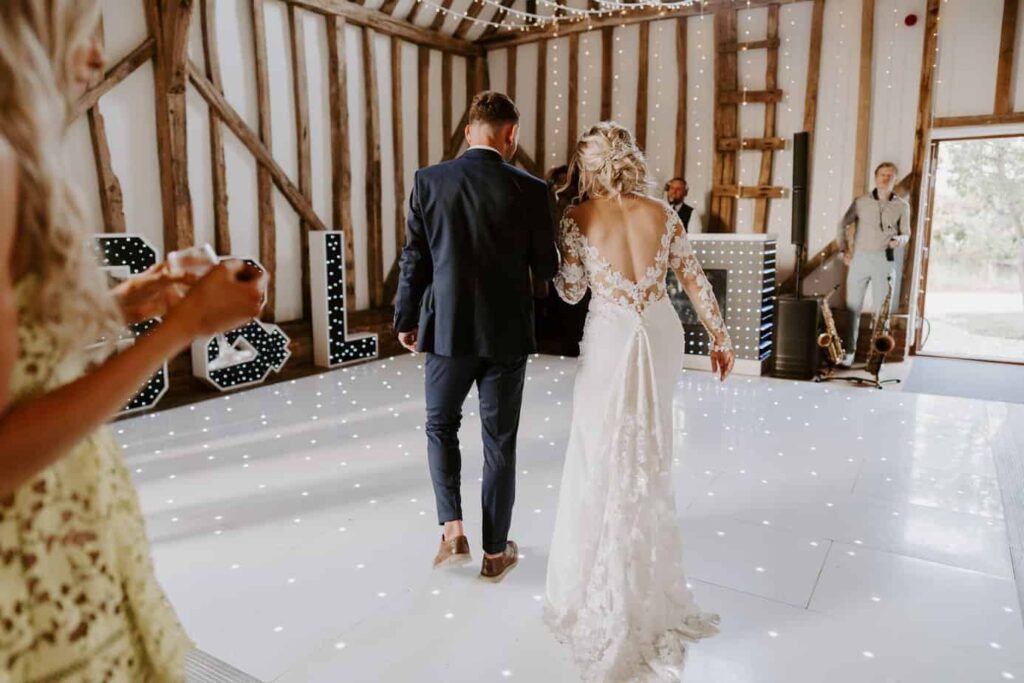 Bride and groom getting ready to dance their first dance on DJ Scott Dewings light up dance floor hire