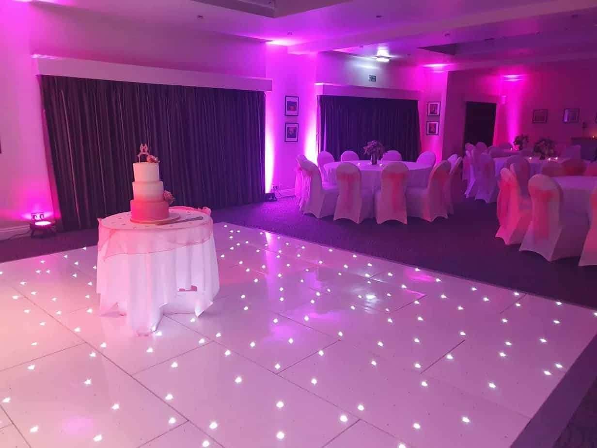 Image of DJ Scott Dewings light up dance floor hire with twinkling lights on and purple lights