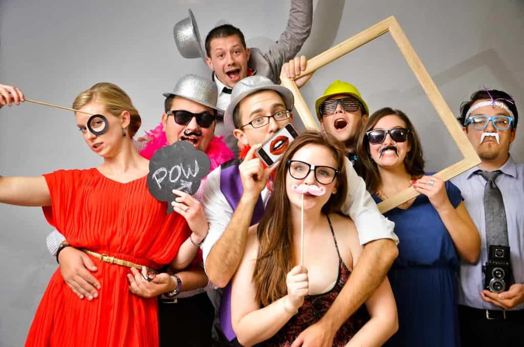 Funny photo of wedding guests enjoying props from DJ Scott Dewings - with the best light up dance floor hire - photo booth hire