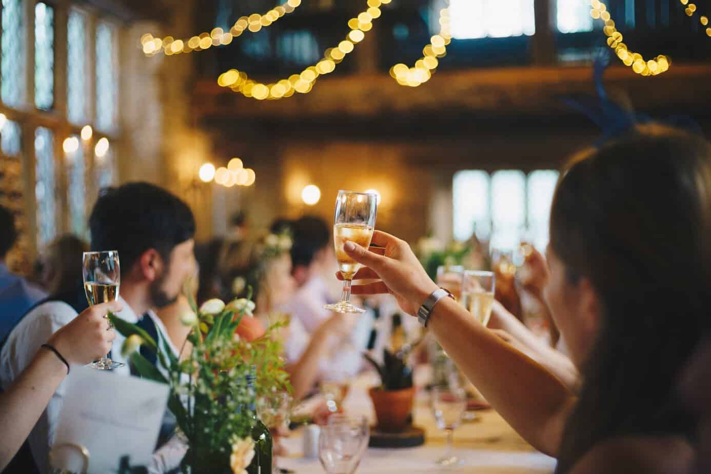 Guests cheering at a wedding with bubbly